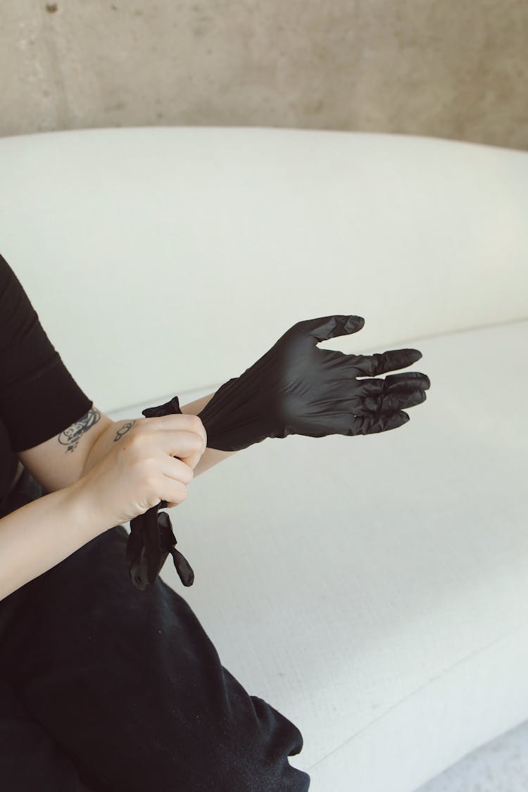 A Person Wearing Black Gloves