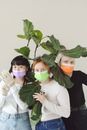 Women Wearing Disposable Face Masks Near Green Plant