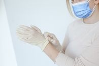 Person in White Long Sleeve Shirt Holding Blue Plastic Container