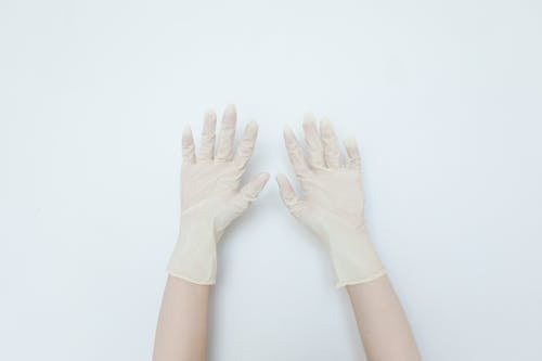 Close-up of Hands in Latex Gloves 