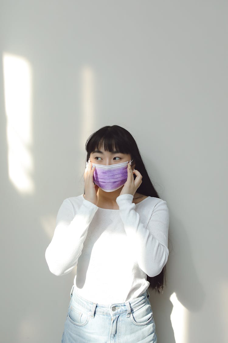 Woman In White Long Sleeve Shirt Wearing Purple Face Mask