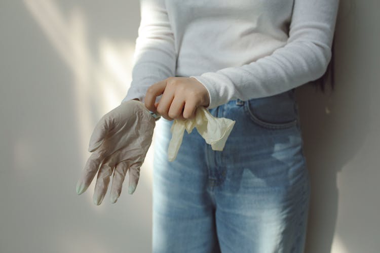 Person In White Long Sleeve Shirt Wearing Latex Gloves