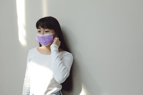 Free Woman Wearing a Purple Medical Mask Stock Photo