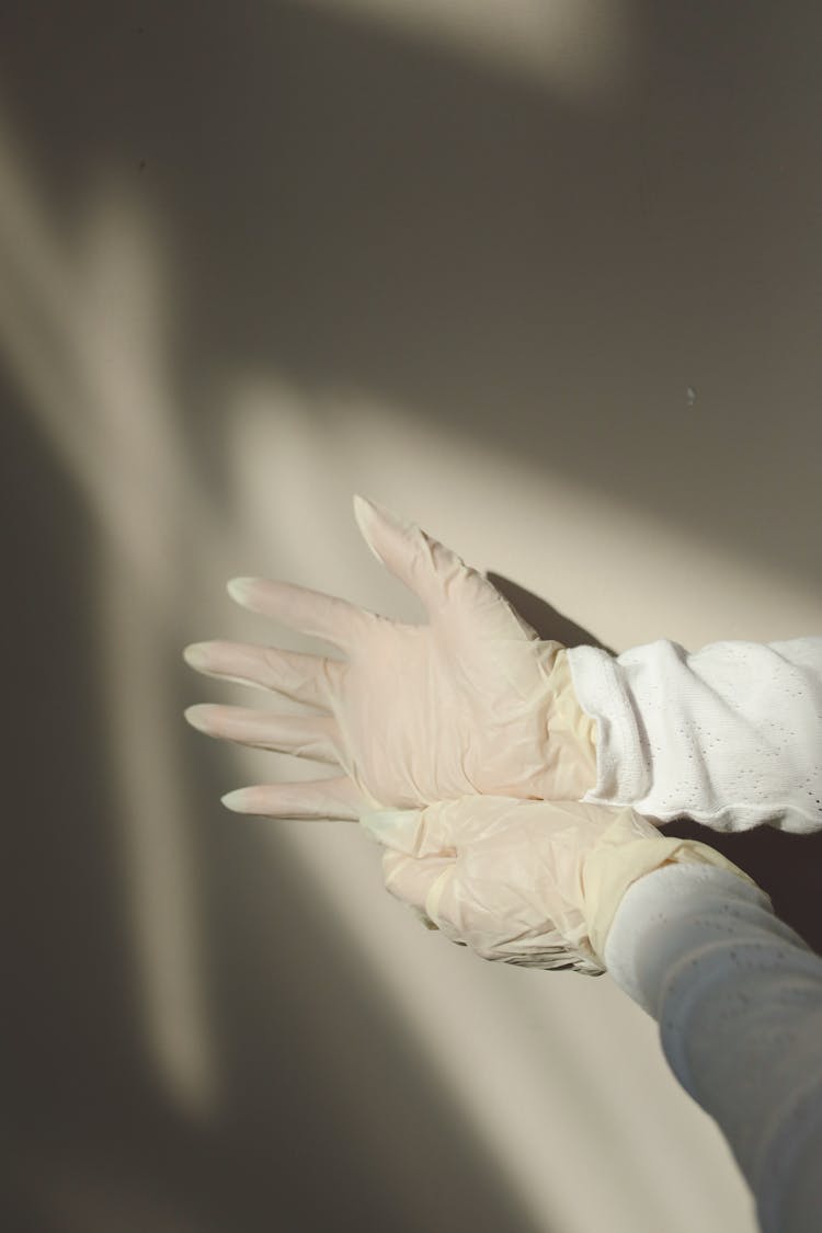 Person Wearing White Latex Gloves