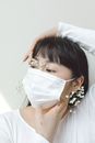 A Woman with Bangs Wearing a Face Mask