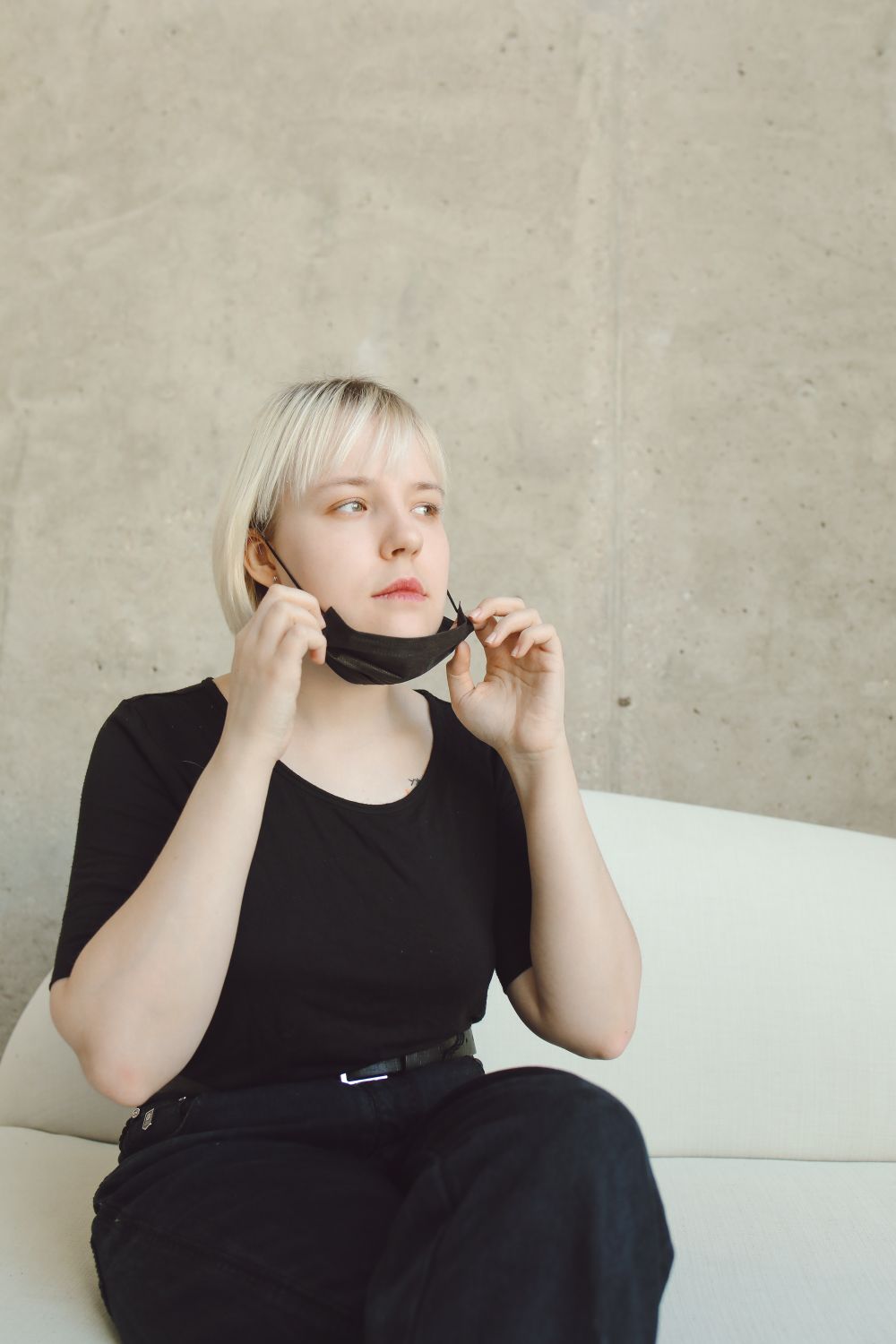 Woman in Black Shirt and Black Pants Sitting on Chair · Free Stock Photo