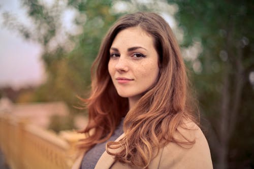 Free Closeup Photo of Woman With Brown Coat and Gray Top Stock Photo