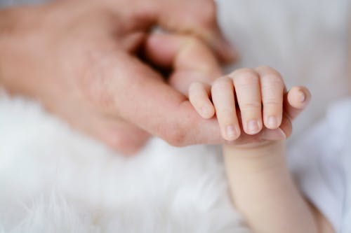 親の指を持っている赤ちゃん