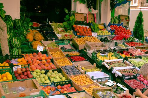Free A colorful assortment of fruits and vegetables at an outdoor farmers market stall. Stock Photo