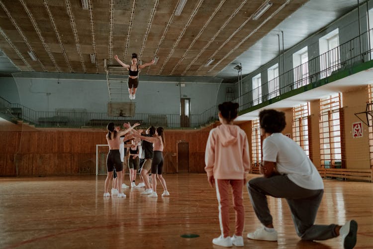 Cheering Practicing At A Gym