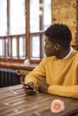 Man in Yellow Sweater Sitting on Chair