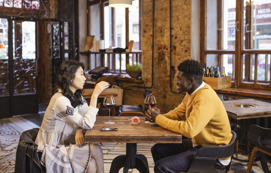 couple smiling at cafe after reconnecting through online dating site
