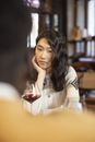Woman in White Long Sleeve Shirt Sitting on Chair