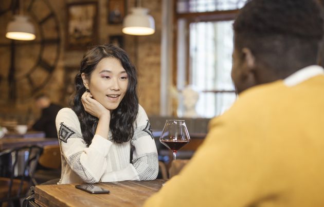 senior couple smiling at a coffee shop after meeting through online dating