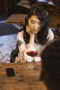 Woman in White Long Sleeve Shirt Holding Wine Glass