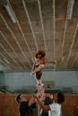 Woman in Black Tank Top and White Shorts Jumping on White Metal Frame