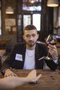 Man in Black Blazer Holding a Glass of Red Wine