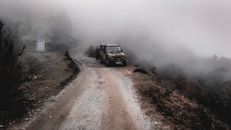 Black Suv on Road Covered With Fog