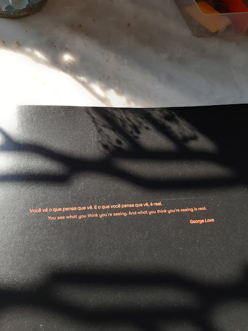 Close-up Photo of a Quote on a Black Paper 