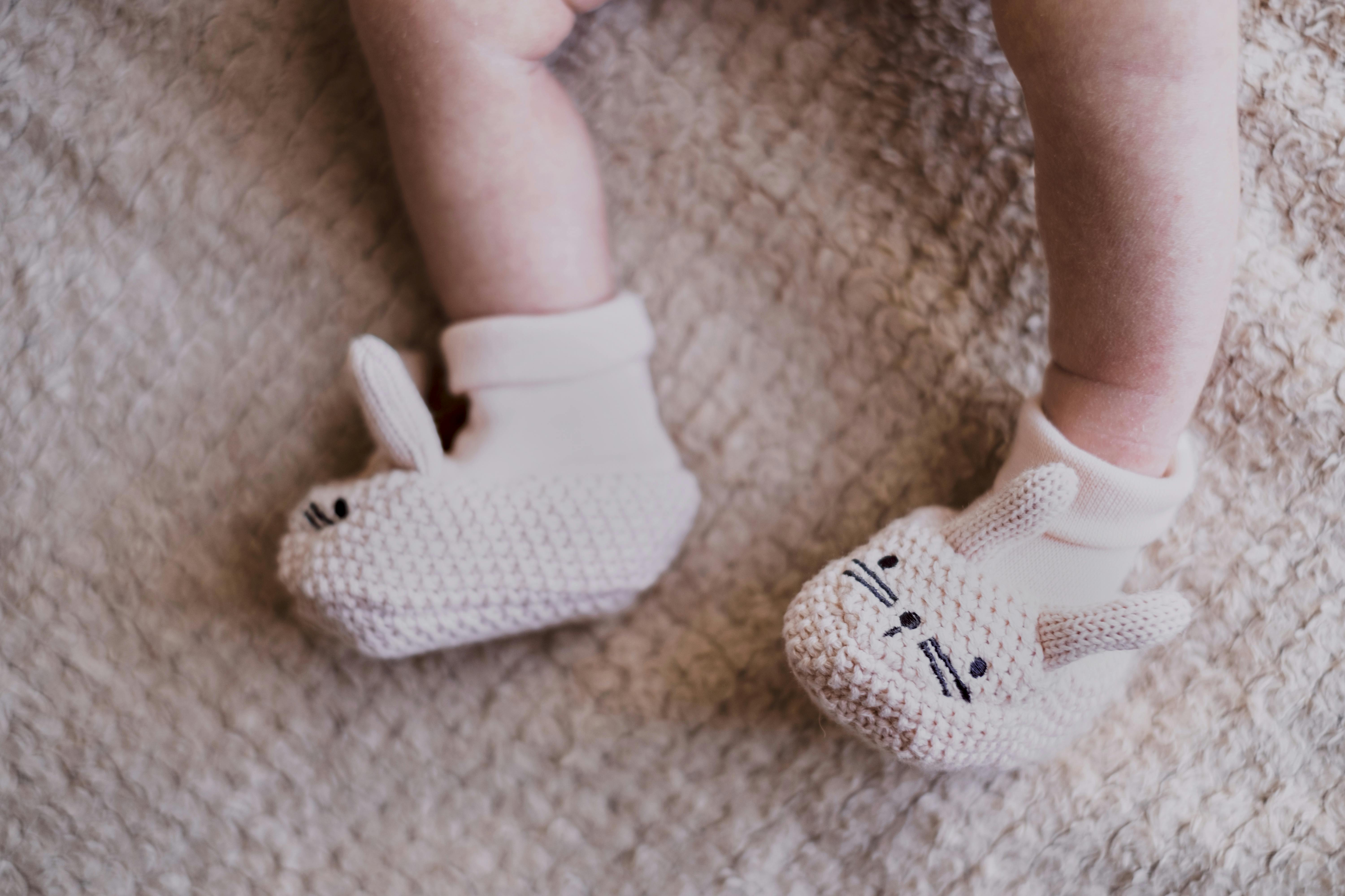 Cute knitted bunny booties on a newborn, perfect for Easter celebrations.