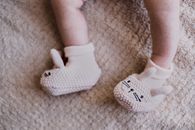 Baby Wearing White Socks on Brown Textile