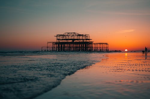 Silhouette of Brighton West Pier on Sea during Sunset