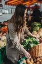 Woman in Gray Coat Holding Basket of Green Vegetable