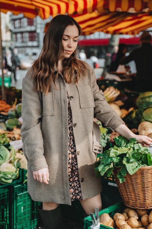 Pretty Woman Standing in the Market of Vegetables