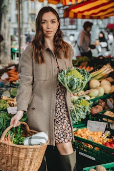 Stylish woman shops for fresh vegetables at Erfurt's outdoor market.