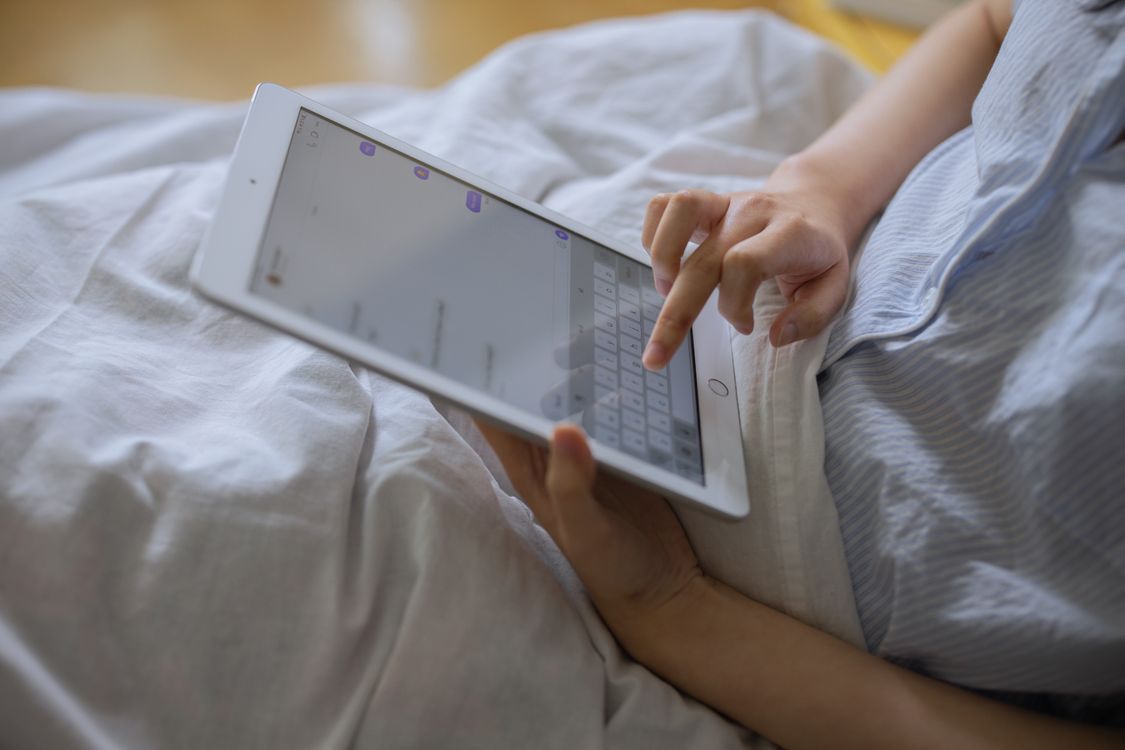 A Person Using a Digital Tablet · Free Stock Photo