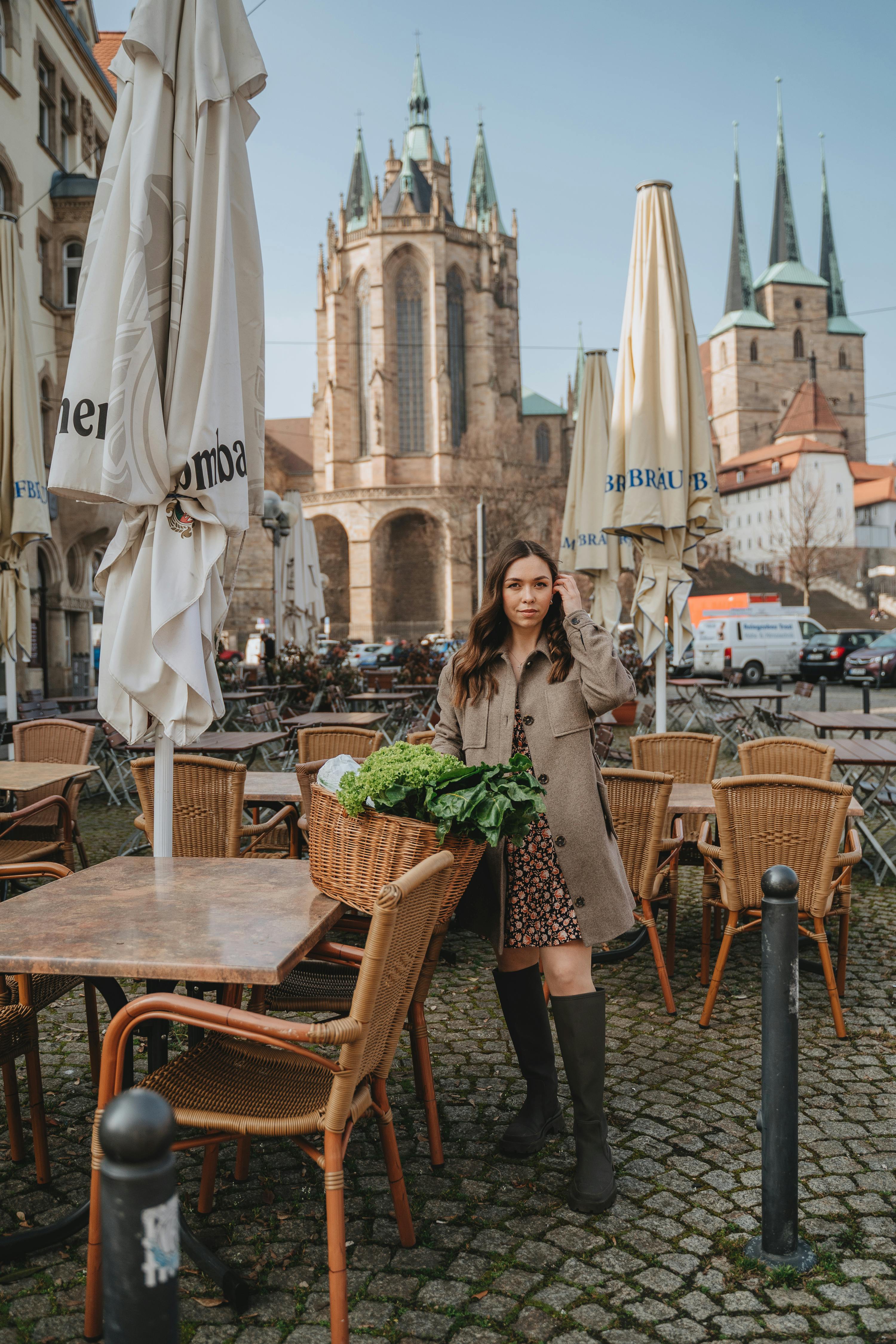 Woman in Black and White Dress Standing Beside Brown Wooden Table