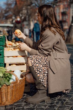 A woman shops for fresh apples at an outdoor market in Erfurt, Germany.