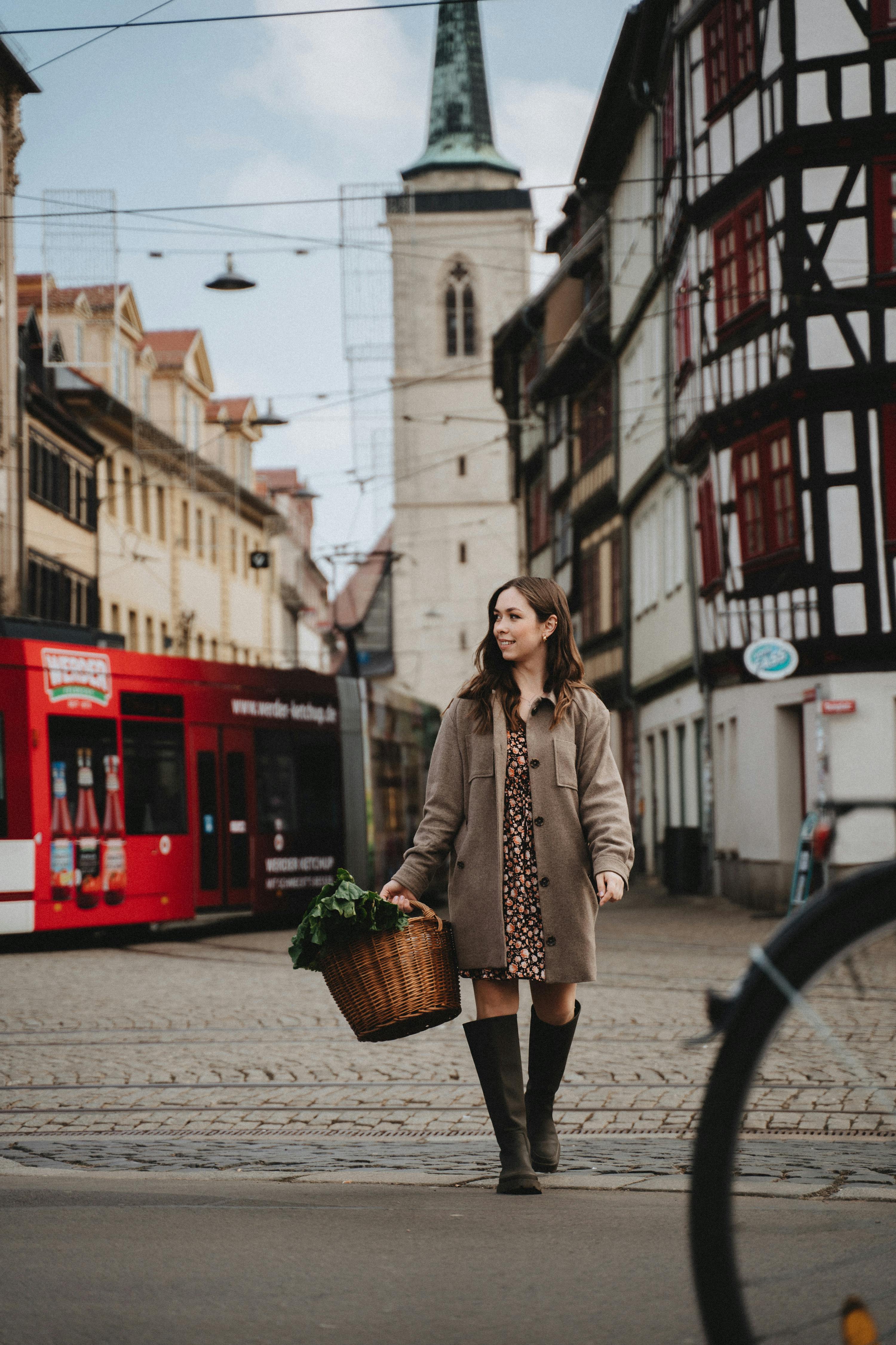 a woman walking with a basket of vegetable