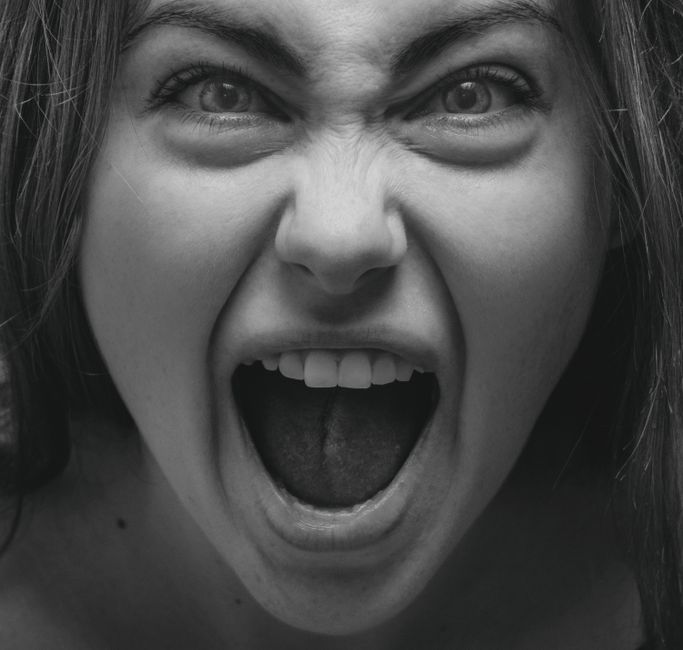 Dramatic grayscale portrait capturing a woman's intense facial expression in Kyiv.