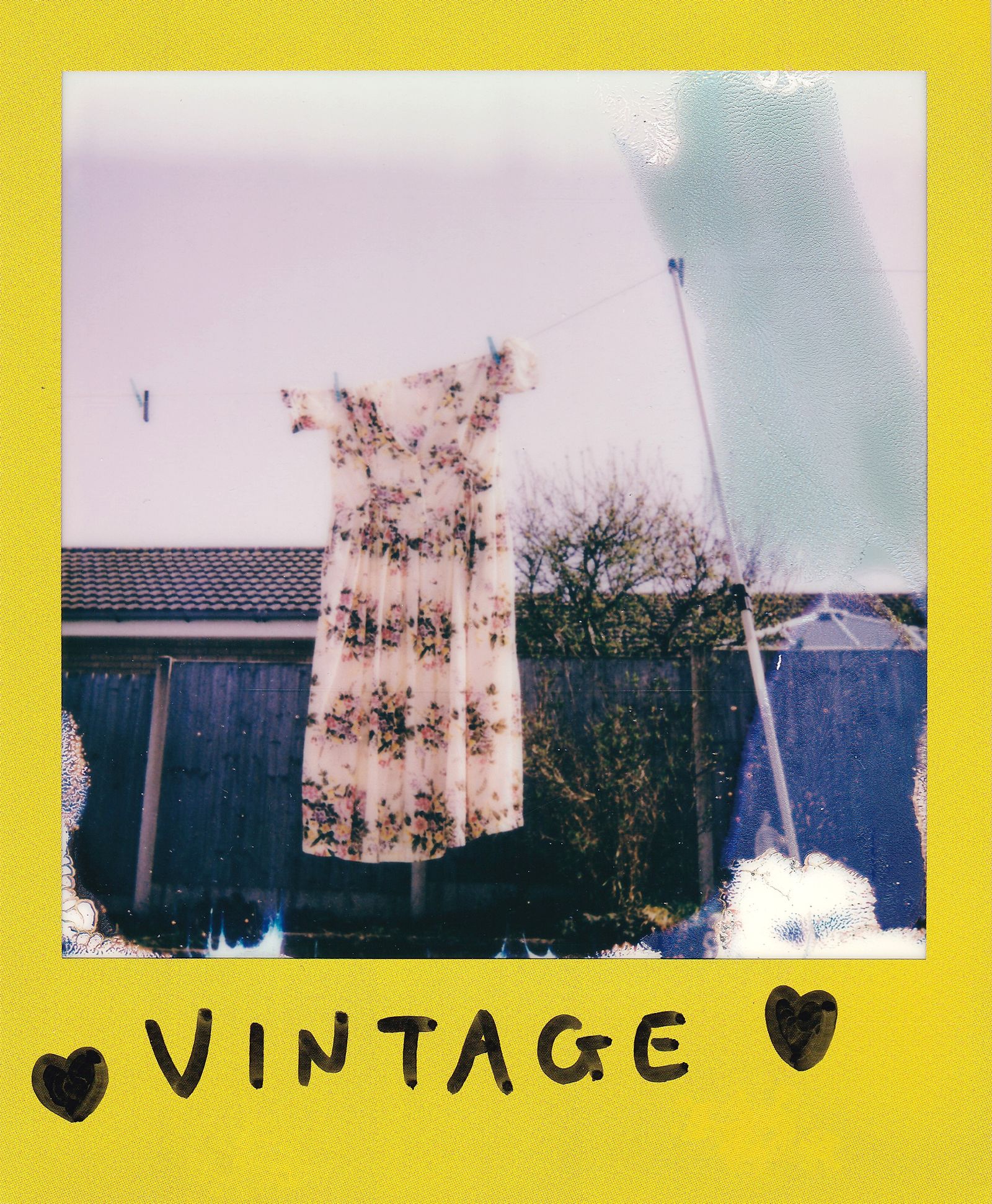 Floral garment hanging outdoors on a clothesline without people