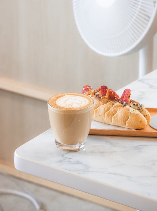 Free Latte on a Clear Drinking Glass on Marble Table Stock Photo