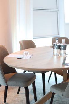 Elegant conference room featuring a wooden table and upholstered chairs, perfect for meetings.