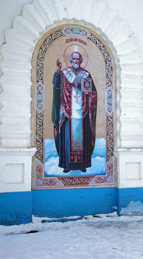 Free Colorful religious mural on an outdoor wall with snow on the ground. Stock Photo