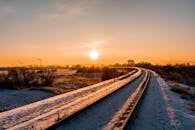 Snow Covered Railroad During Sunset