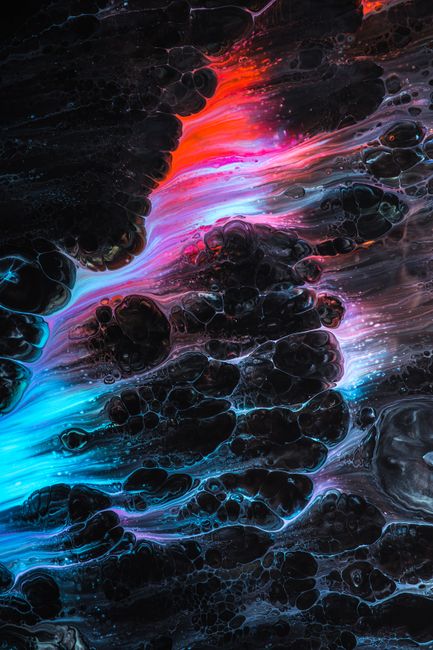 Dynamic abstract fluid art featuring vibrant neon waves of red, blue, and pink against a dark background.