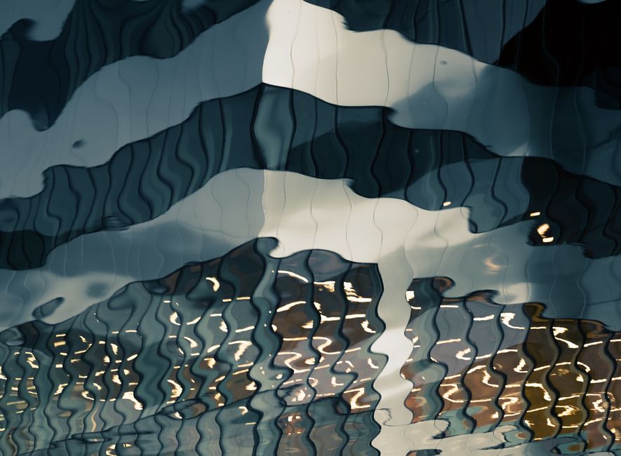 Artistic capture of rippling water reflections creating an abstract play of light and shadow.
