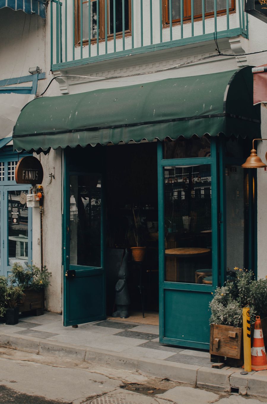 Stock photo of an older storefront with a weathered green awning
