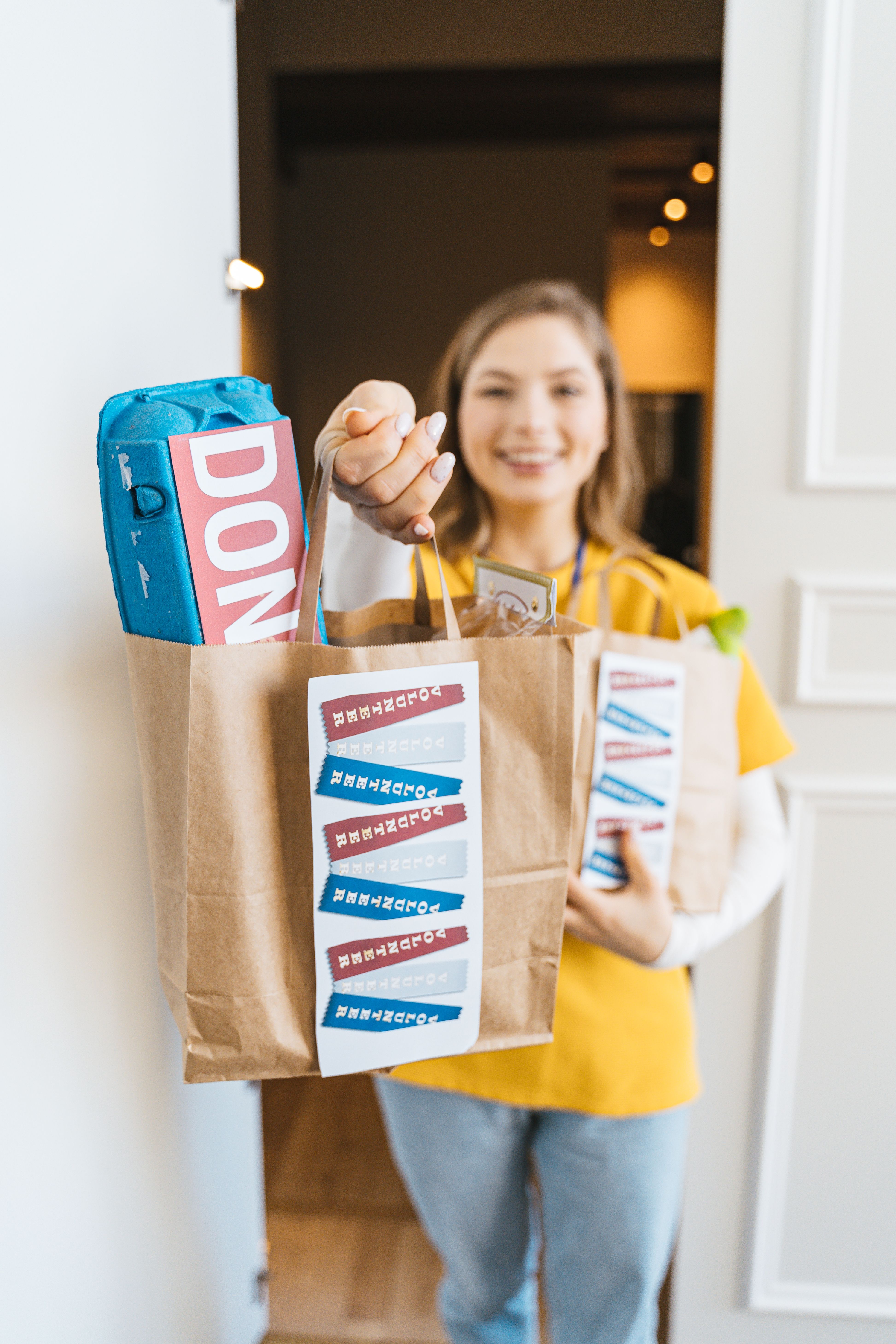 Woman holding grocery bags at a doorstep, representing Instacart and Spark delivery work