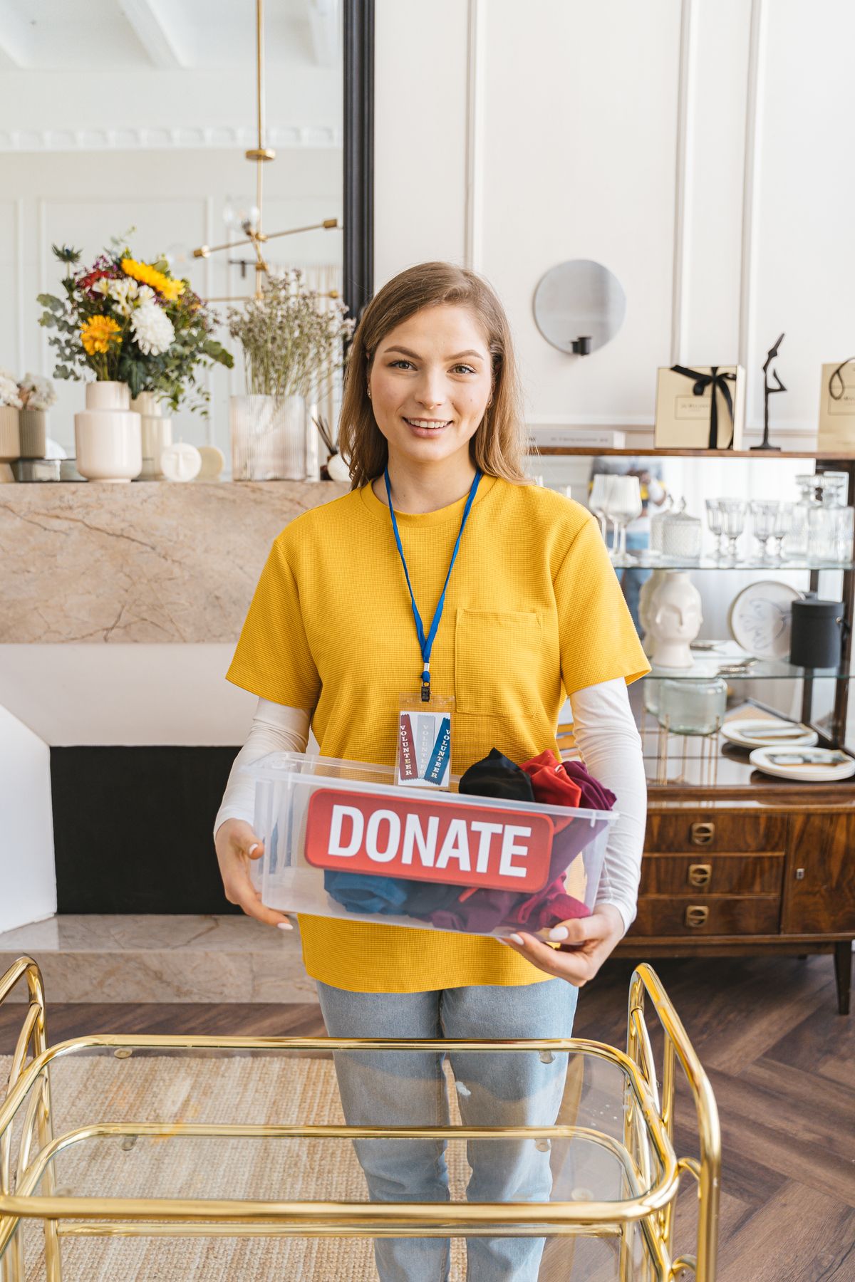 Smiling volunteer holding a donation box