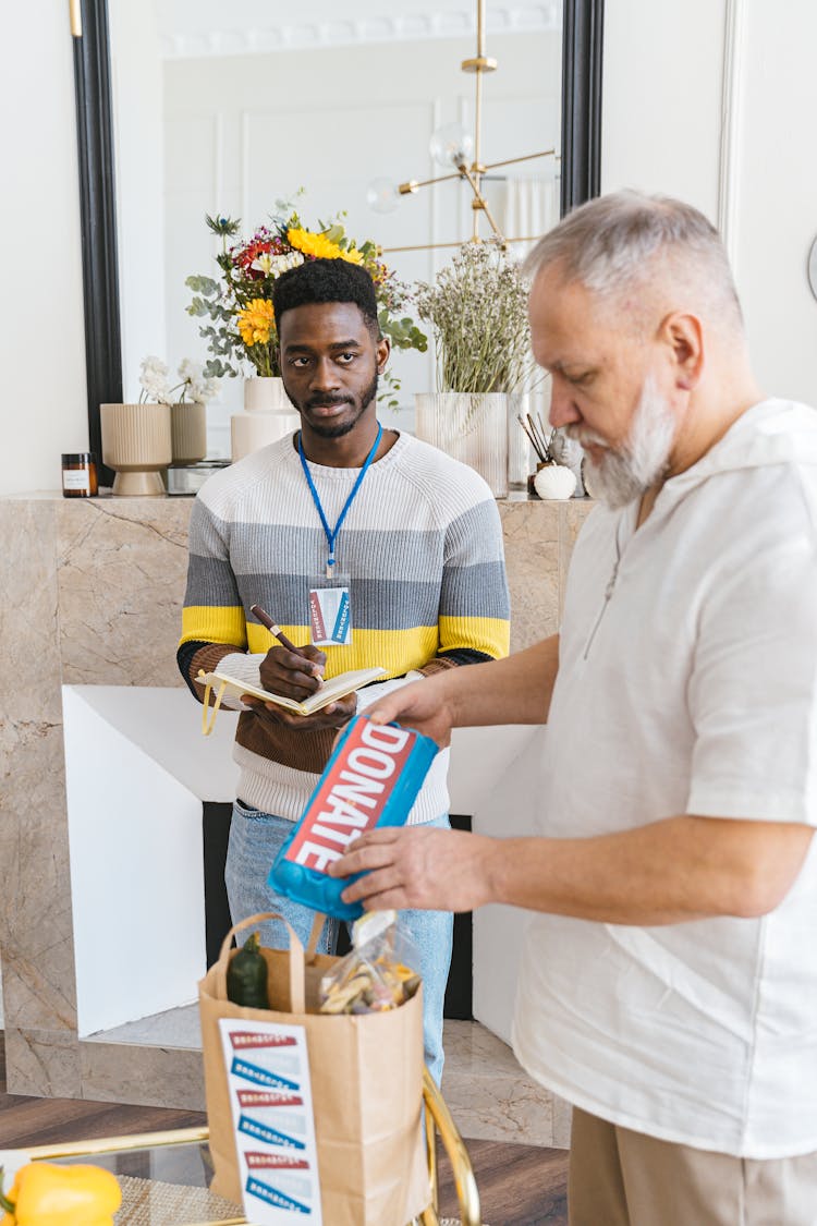 A Man Making A Donation Placed In Paper Bag