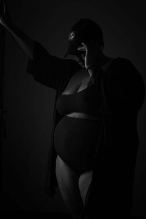 Free Dramatic black and white studio portrait of a plus size model posing in stylish attire. Stock Photo