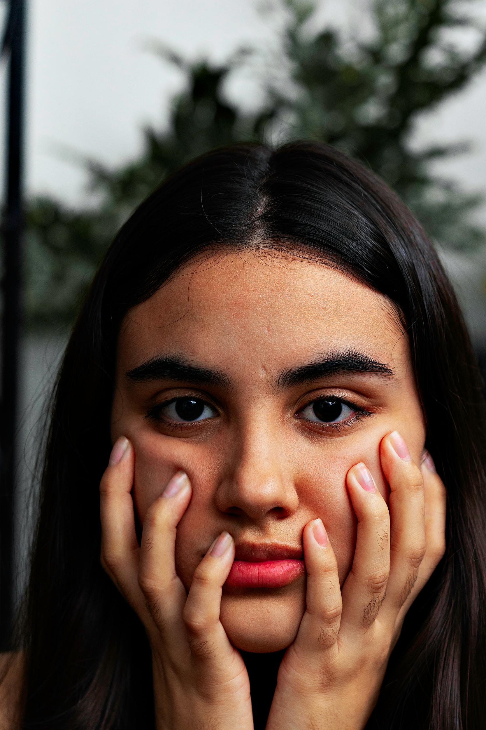 Woman with hands on her face - Stock Image - C031/0641 - Science