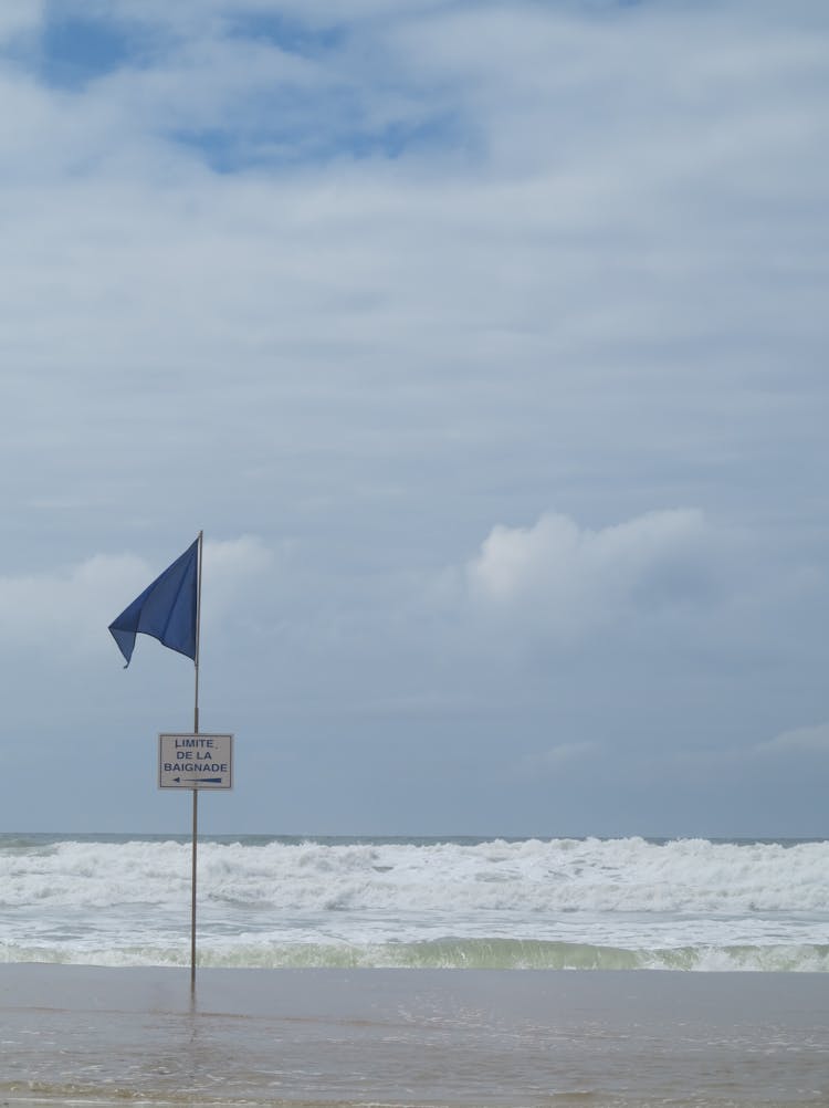 Flag On Sea Beach In Storm