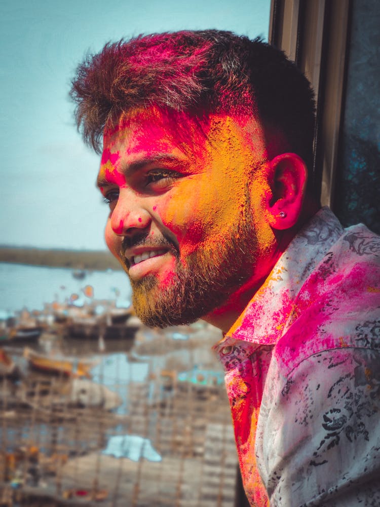 Man With Orange And Red Powder On His Face