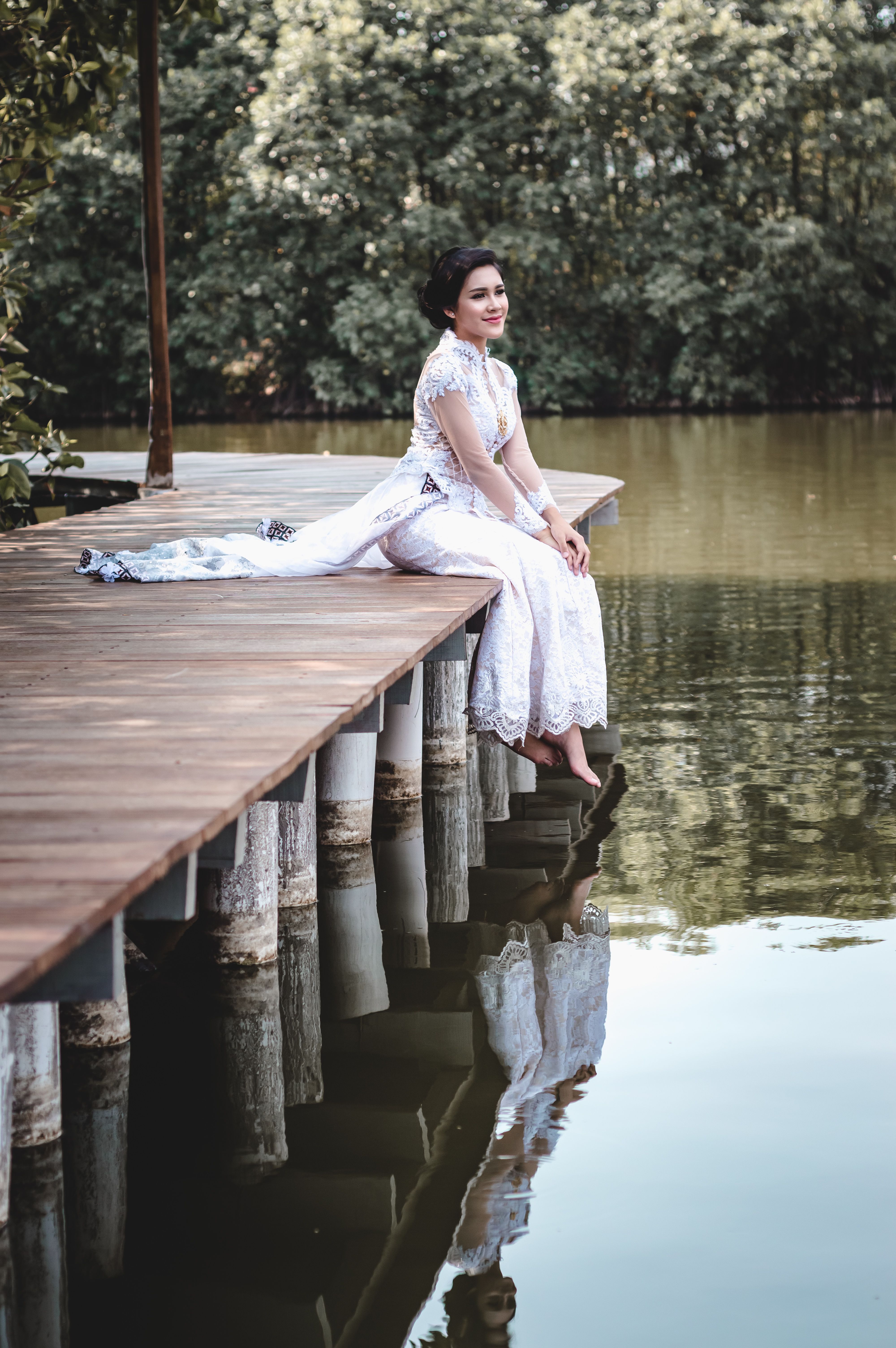Woman in White Dress Sitting on Brown Wooden Dock · Free Stock Photo